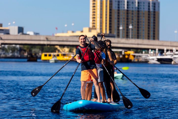 a man riding on the back of a boat in a body of water